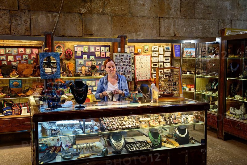 Merchants in illuminated catacombs