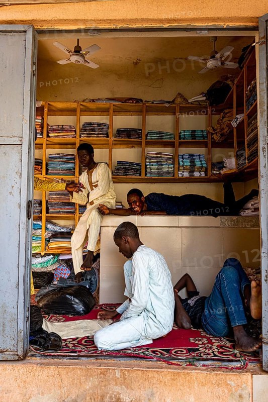 Boys hanging out in a shop in the bazaar