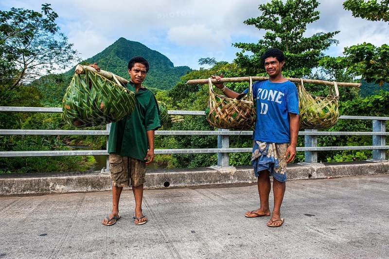 Local farmers bringing their goods in palm baskets back home