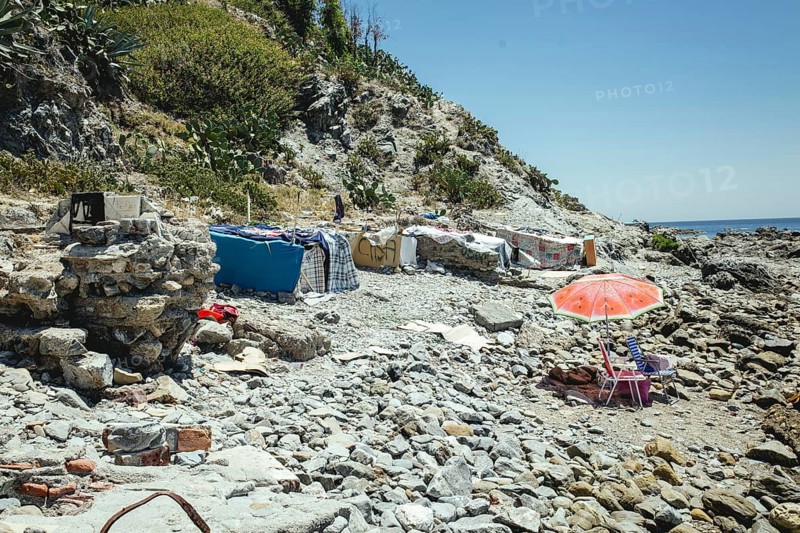 Tents and self-constructed huts on the cliff at the coastal section El Sarchal