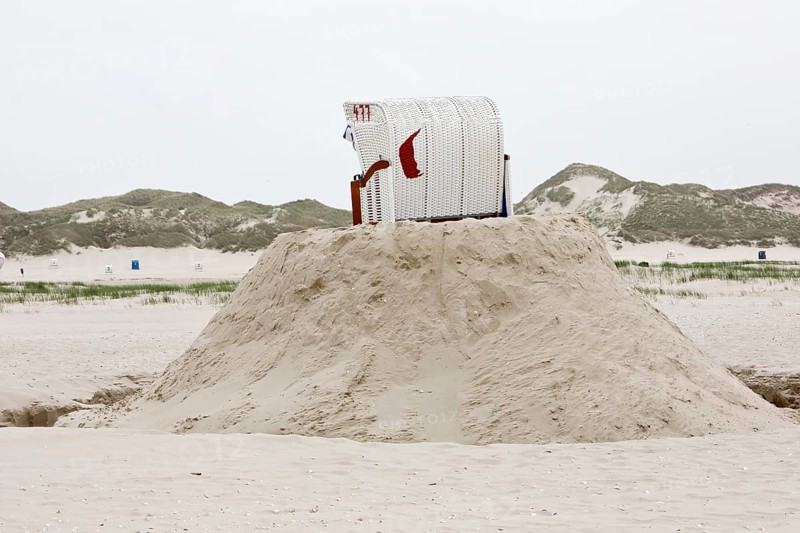 Beach chair on a built sand hill at the beach