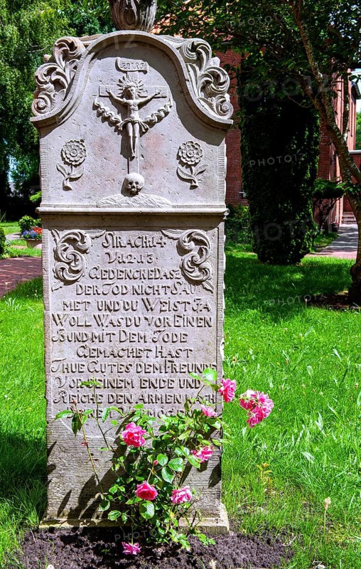 Historic sandstone gravestone from the 18th century in the churchyard of St. Nicholas Church