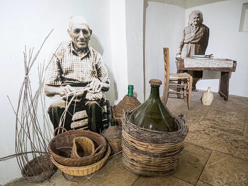 Farmer weaving a basket and farmer's wife at the dining table