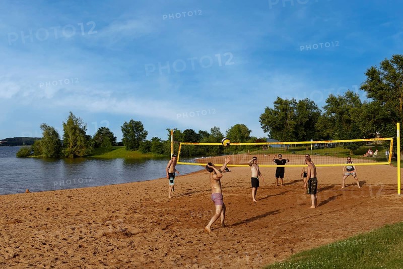 Men playing beach volleyball
