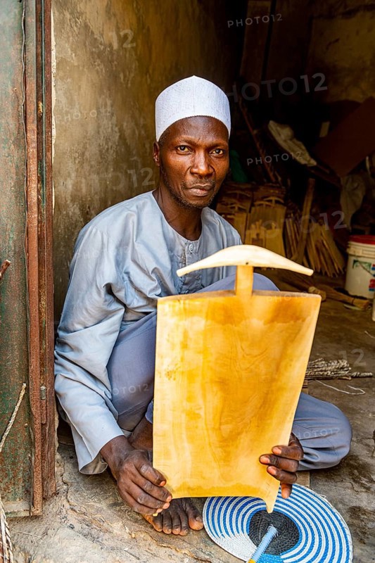 Man carving the Quoran on a wooden board