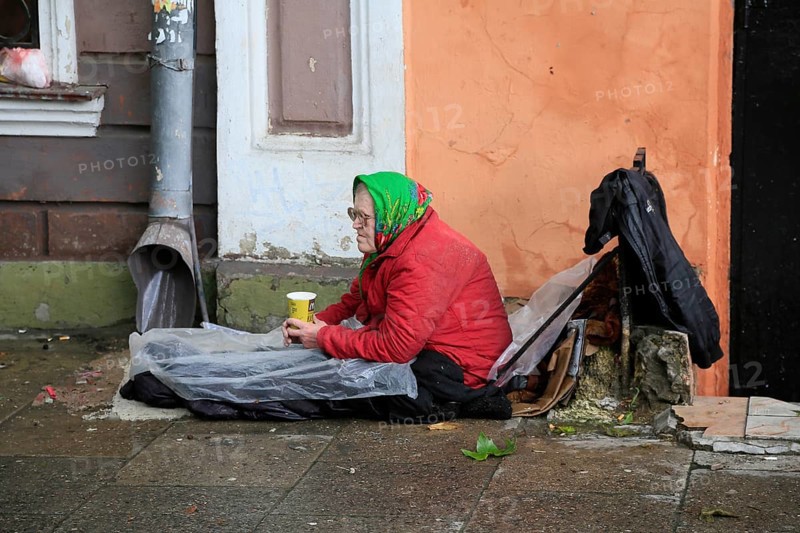 Old woman sitting on the floor
