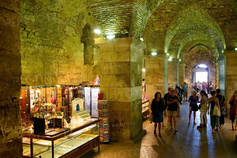 Merchants in illuminated catacombs