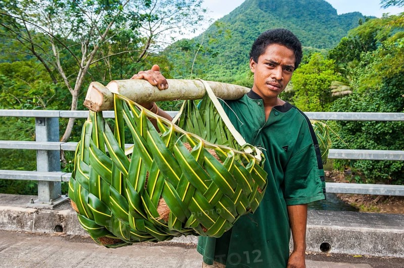 Local farmer bringing his goods in palm baskets back home