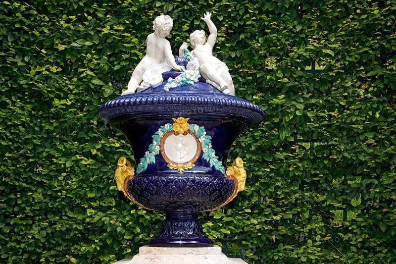 Ornamental glazed ceramic vessel with putti