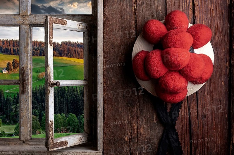 Rustic farmhouse parlor with Bollen hat and view out of the window into the landscape