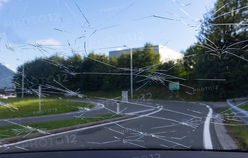 Shattered windscreen due to hailstones on a car