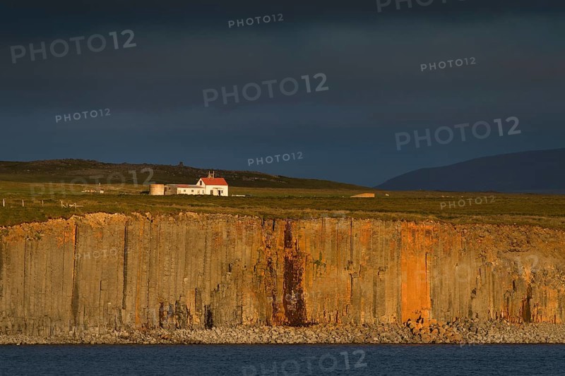 Farm and basalt cliff in the evening light