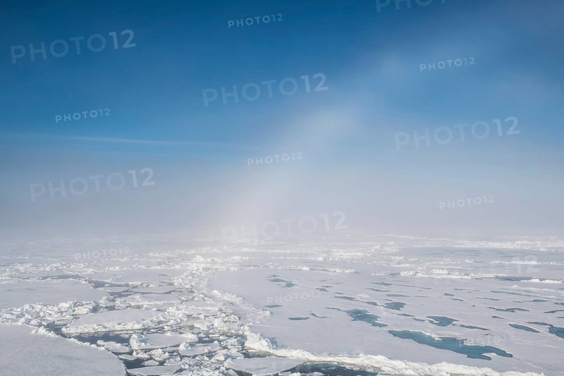 Fog bow or white rainbow in the ice around the North Pole