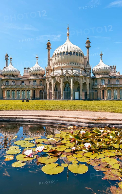 Royal Pavilion palace reflected in a pond with water lilies