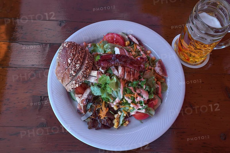 Salad with roasted turkey strips served in a garden restaurant