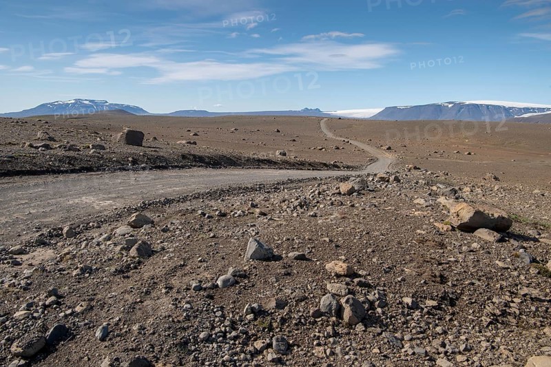 Lonely gravel road through volcanic landscape