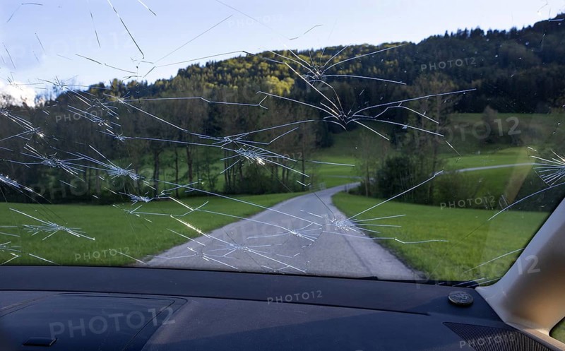 Shattered windscreen due to hailstones on a car