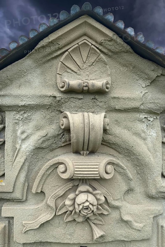 Ornaments and symbol of a rose on a gravestone