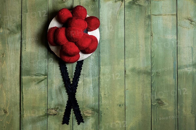 Original Black Forest Bollen hat in front of green wooden wall