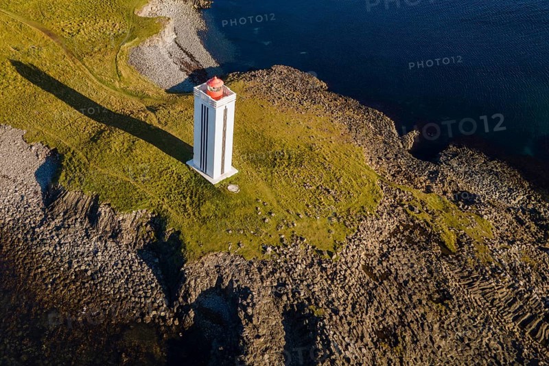 Lighthouse and coastal landscape with basalt formations