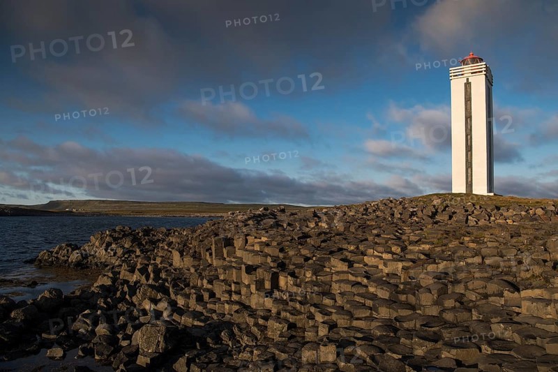 Lighthouse and coastal landscape with basalt formations