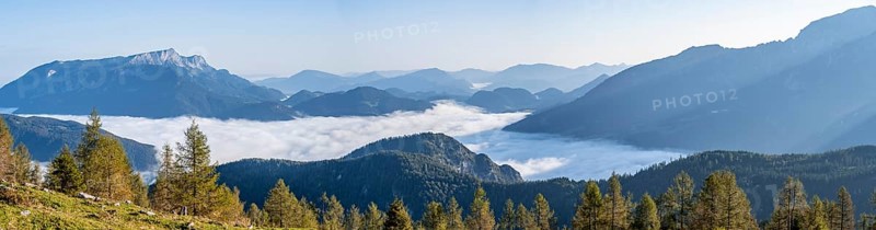 Hiker sitting on a bench and looking over the landscape