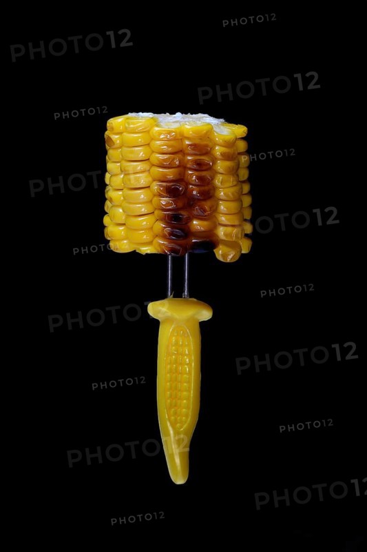 Grilled corn on the corn cob on a corn on the cob holder