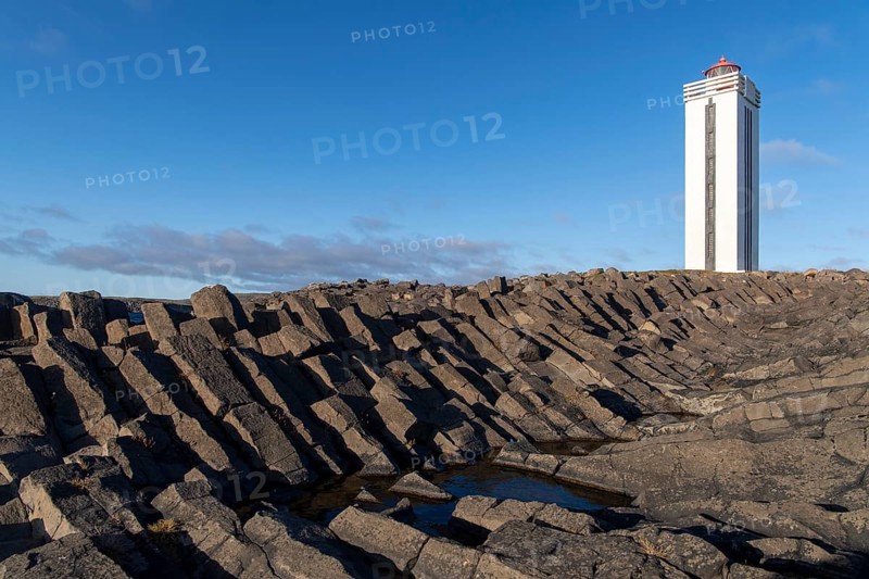 Lighthouse and coastal landscape with basalt formations