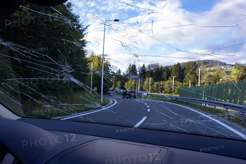 Shattered windscreen due to hailstones on a car