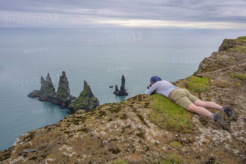Woman photographing the Reynisdrangar