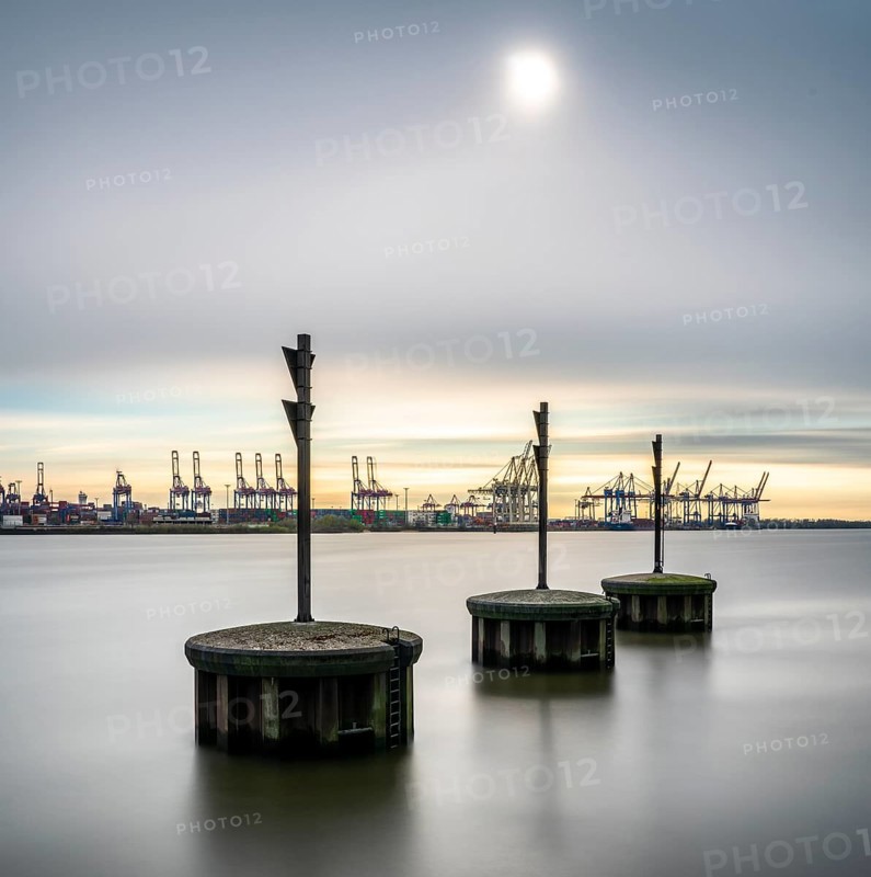 Long exposure of concrete bollards in the river Elbe at the port of Hamburg
