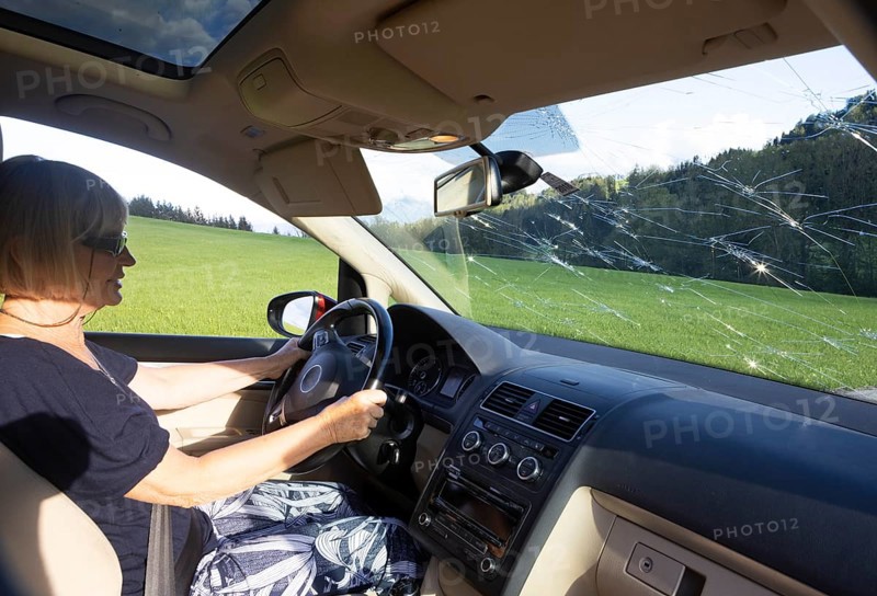 Shattered windscreen due to hailstones on a car