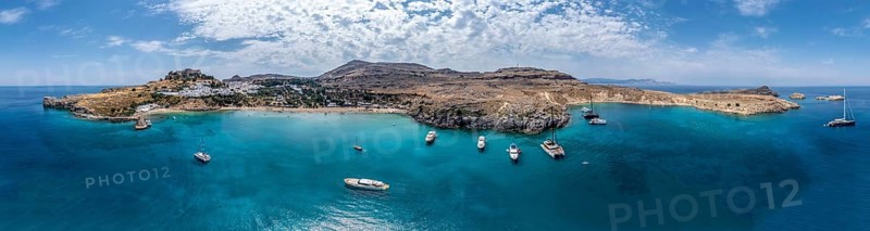 Sailboats anchoring in front of Lindos