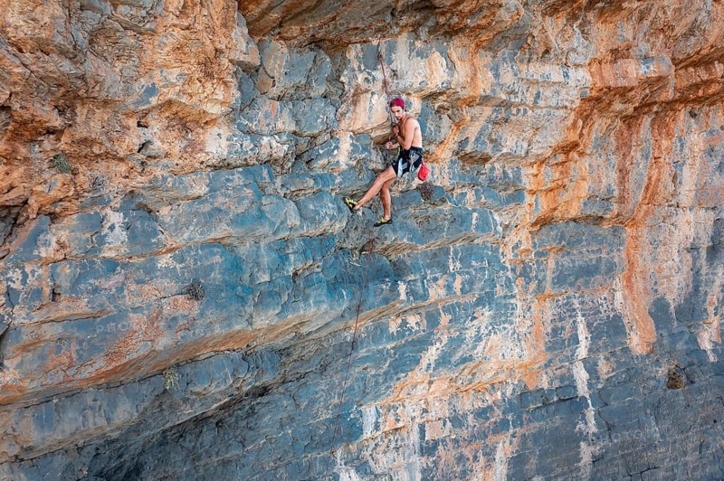 Climber climbing on a rock face
