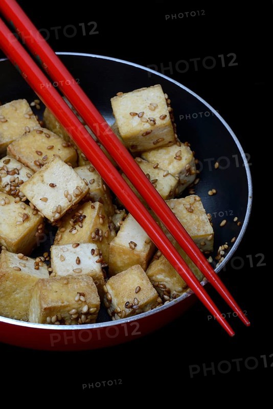 Fried tofu cubes in pan