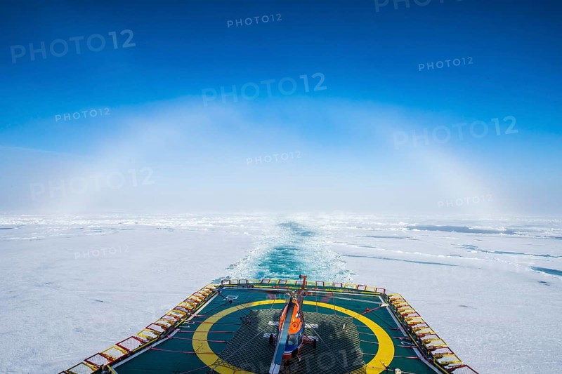 Fog bow or white rainbow in the ice around the North Pole