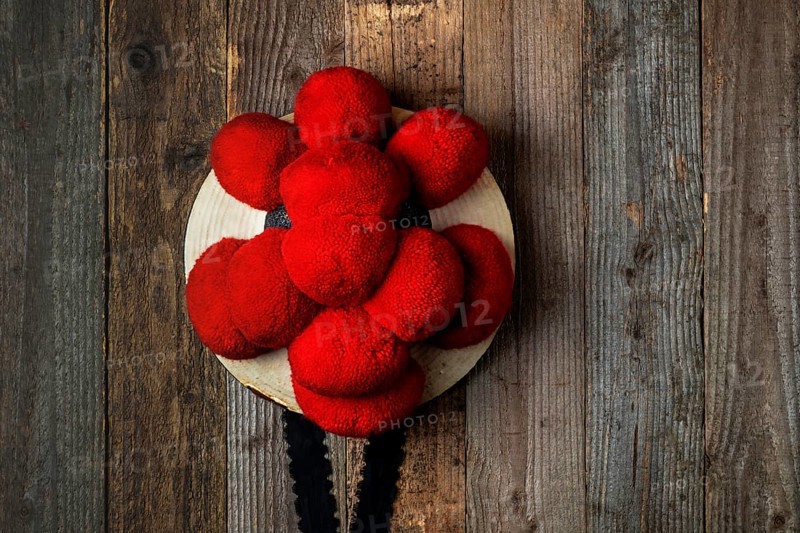 Original Black Forest Bollen hat in front of rustic wooden wall