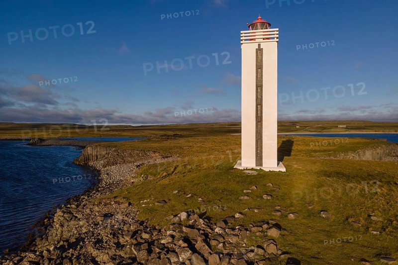 Lighthouse and coastal landscape with basalt formations