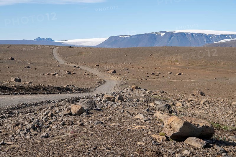 Lonely gravel road through volcanic landscape