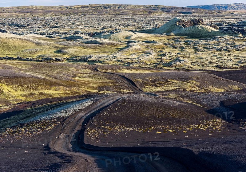 Unpaved road leads through moss-covered Laki Crater or Lakagigar