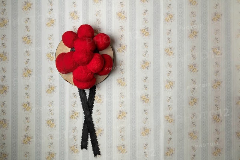 Original Black Forest Bollen hat in front of old-fashioned wallpaper wall