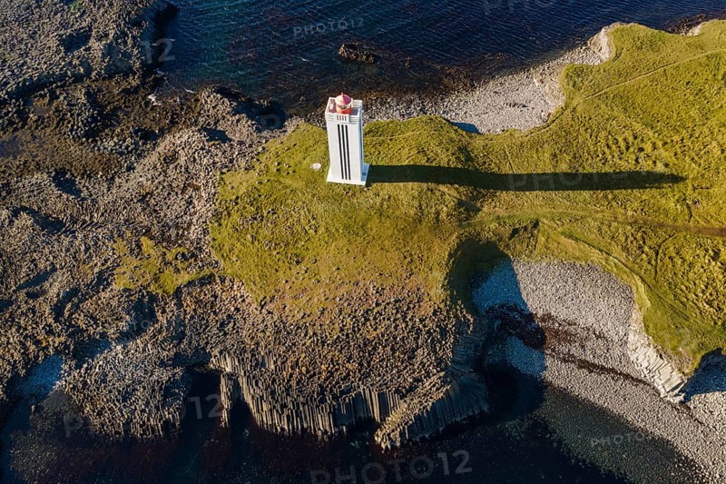 Lighthouse and coastal landscape with basalt formations