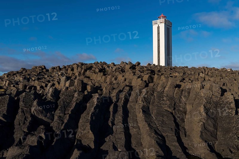 Lighthouse and coastal landscape with basalt formations