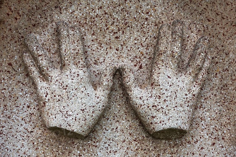 Symbol of blessing priest hands on a gravestone