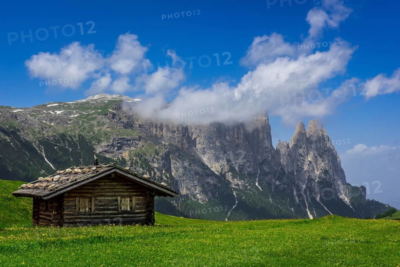 Alpine huts in front of the Schlern massif