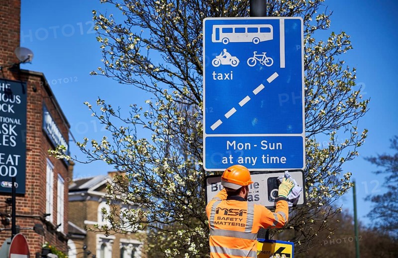 Construction worker cleaning traffic sign