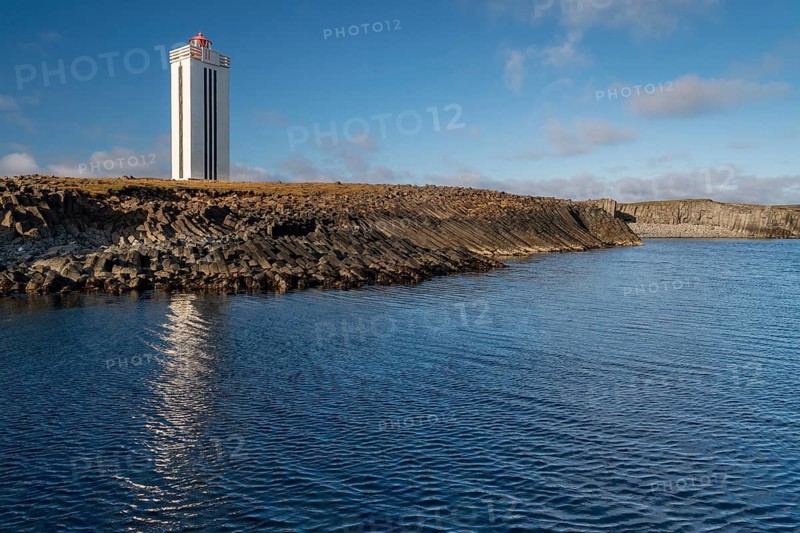 Lighthouse and coastal landscape with basalt formations and basalt cliff