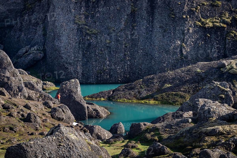 Man standing at turquoise water pool