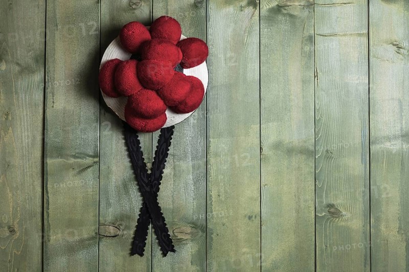 Original Black Forest Bollen hat in front of green wooden wall