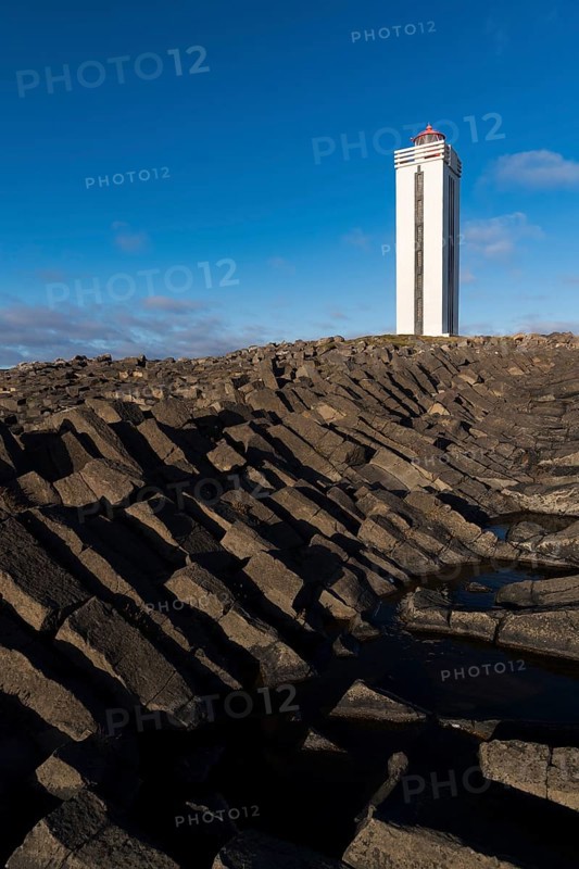 Lighthouse and coastal landscape with basalt formations